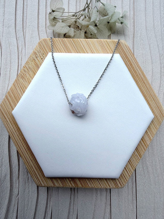 Dreamy Jade lavender jade pendant necklace with hand-carved floral motif on a minimalist silver-tone chain.