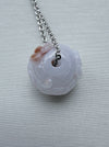 Dreamy Jade lavender jade pendant necklace with hand-carved floral motif and silver-tone chain on a neutral background.