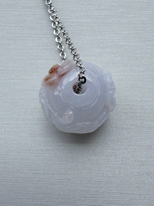 Dreamy Jade lavender jade pendant necklace with hand-carved floral motif and silver-tone chain on a neutral background.