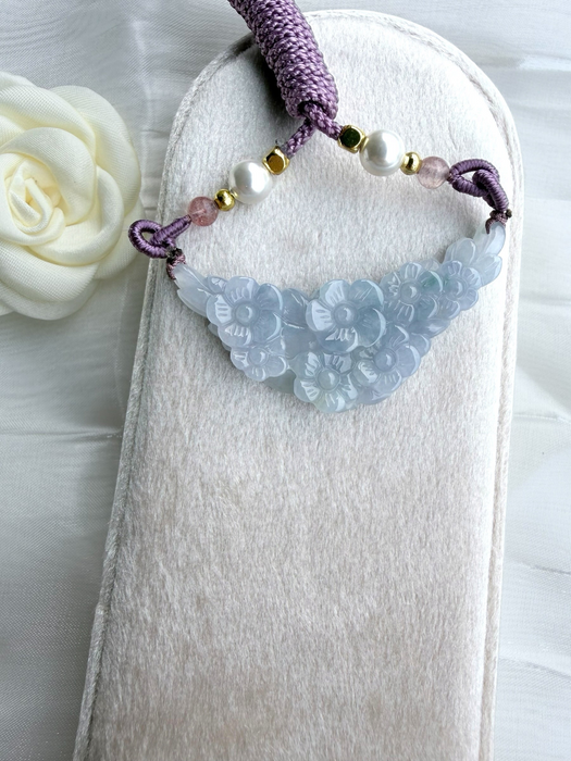 Dreamy Jade lavender jadeite pendant with hand-carved floral motif, purple braided cord, pearls, and gold-tone spacers.
