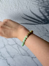Dreamy Jade multi-colour jade bead bracelet featuring a gradient of green and earthy tones on a wrist