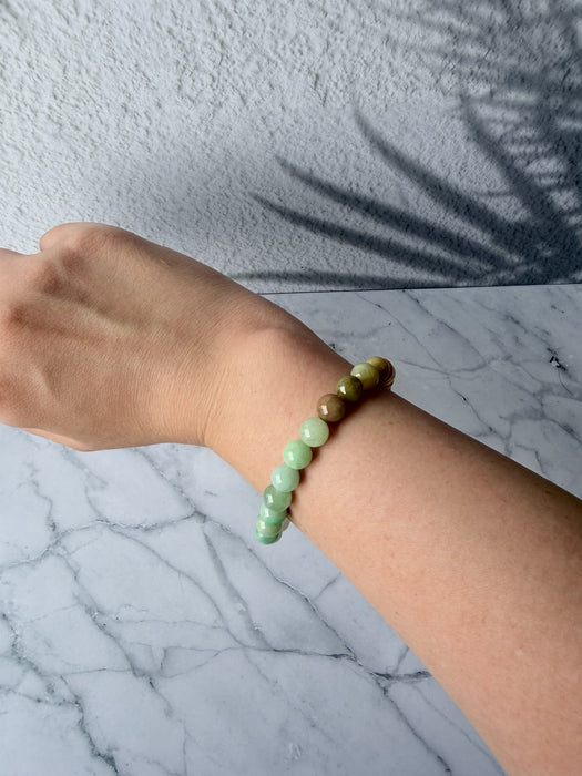 Dreamy Jade multi-colour jade bead bracelet featuring a gradient of green and earthy tones on a wrist