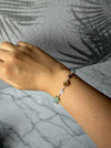 Dreamy Jade multi-coloured clover bracelet in 925 sterling silver worn on a wrist against a marble background.