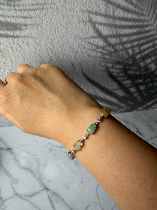 Dreamy Jade sterling silver link bracelet featuring multi-coloured green and yellow jade stones and cubic zirconia.