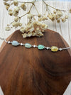 Dreamy Jade multi-coloured jade and sterling silver link bracelet with cubic zirconia accents on a wooden display