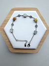 Dreamy Jade multi-coloured jade gemstone link bracelet with 925 sterling silver coin charms on a white display stand.