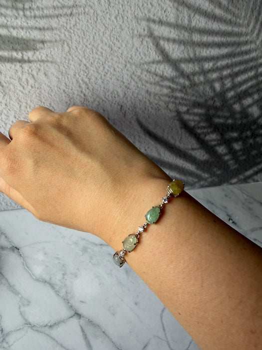 Dreamy Jade sterling silver link bracelet featuring multi-coloured green and yellow jade stones and cubic zirconia.