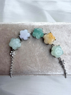 Dreamy Jade multi-coloured floral carved jade gemstone link bracelet with silver-tone chain on a velvet display
