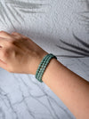 Dreamy Jade multi-layer bracelet featuring smooth, translucent sea-green jade beads on a woman's wrist.