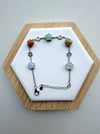 Dreamy Jade sterling silver chain bracelet featuring multi-coloured star-shaped jade stones and coin charms.