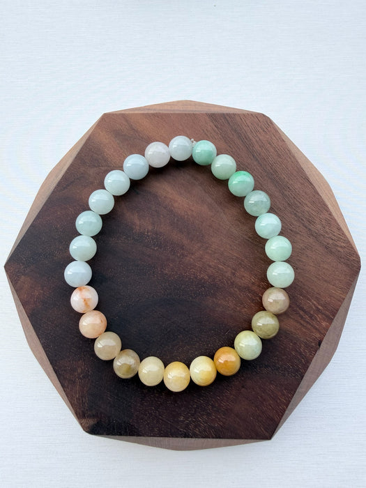 Dreamy Jade multi-colour jade bead bracelet with a gradient of green, white, and amber polished round beads.