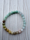 Dreamy Jade multi-colour round bead bracelet featuring a smooth gradient of green, white, and amber polished jade.
