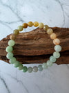 Dreamy Jade multi-colour jade bead bracelet featuring a gradient of green, white, and amber polished round beads.
