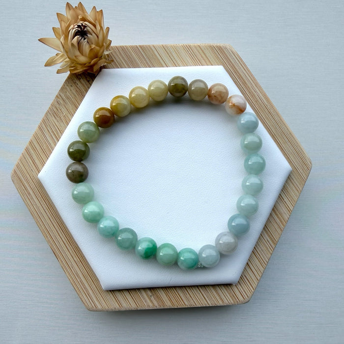 Dreamy Jade multi-colour jade bead bracelet featuring a gradient of green, white, and amber polished gemstone beads.