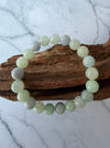 Dreamy Jade bracelet featuring polished natural jadeite beads in soft mint green and lavender hues on driftwood