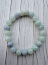 Dreamy Jade round bead bracelet featuring polished natural jadeite in soft mint green and lavender hues.
