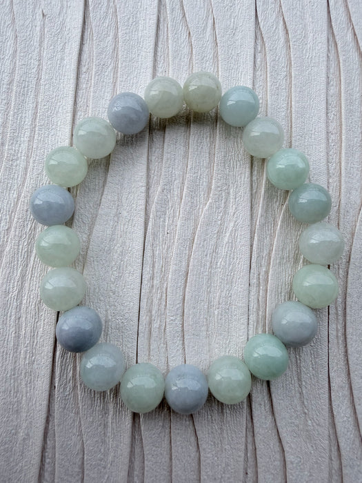 Dreamy Jade round bead bracelet featuring polished natural jadeite in soft mint green and lavender hues.
