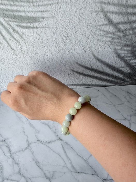 Dreamy Jade natural jadeite bead bracelet with polished mint green and lavender beads on a wrist