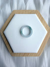 Dreamy Jade elegant natural jadeite ring band with translucent icy base and vibrant green splashes on a white display
