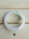 Dreamy Jade natural jadeite ring band with a smooth polished finish and subtle green inclusions on a beige display