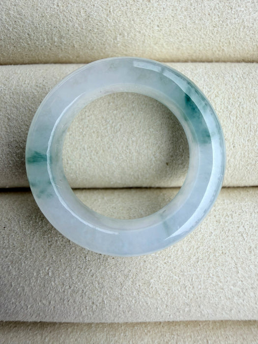 Dreamy Jade elegant natural jadeite ring band with translucent icy base and vibrant green splashes on velvet display