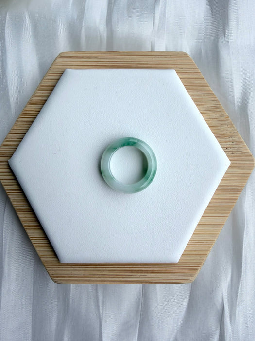 Dreamy Jade natural jadeite ring featuring a smooth polished band with translucent white and emerald green hues.