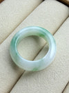 Dreamy Jade natural jadeite ring featuring a polished translucent white band with vibrant emerald green splashes.
