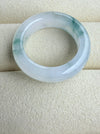 Dreamy Jade elegant natural jadeite ring band with translucent icy base and vibrant green splashes on a velvet tray.
