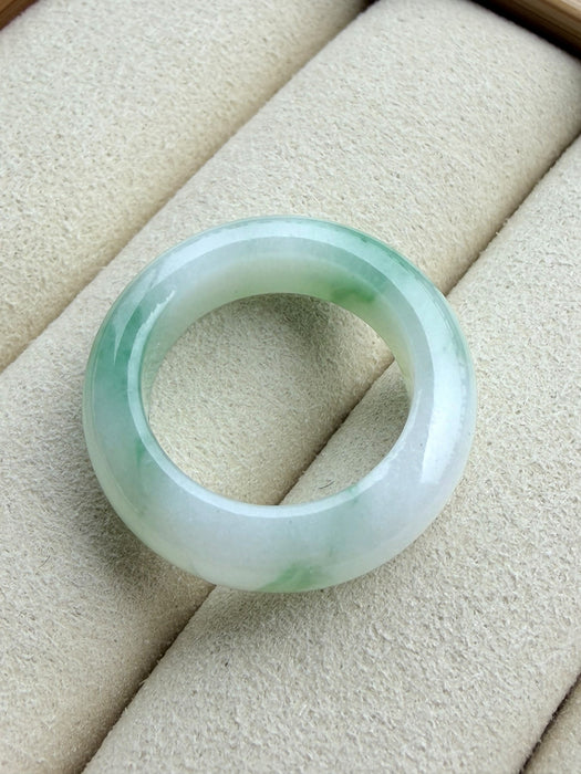 Dreamy Jade natural jadeite ring featuring a polished translucent white band with vibrant emerald green splashes.