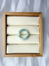 Dreamy Jade natural jadeite ring featuring a smooth polished band with translucent white and emerald green hues.