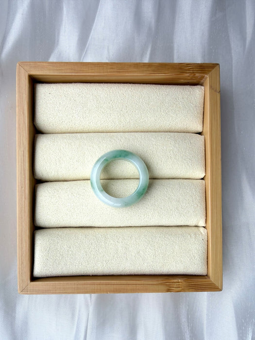 Dreamy Jade natural jadeite ring featuring a smooth polished band with translucent white and emerald green hues.