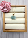 Dreamy Jade peony pendant necklace in translucent green jade with a gold-tone leaf bail on a delicate box chain.