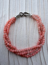 Dreamy Jade triple-strand pink gemstone beaded bracelet with a silver-tone infinity clasp featuring pavé crystals.