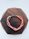 Dreamy Jade triple-strand pink gemstone beaded bracelet with a silver-tone infinity clasp featuring pavé crystals.