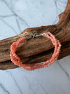 Dreamy Jade triple-strand pink gemstone beaded bracelet with a silver infinity clasp featuring pavé crystals.
