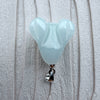 Dreamy Jade rabbit pendant in smooth pale green jade with a polished silver-tone bail on a textured white background.
