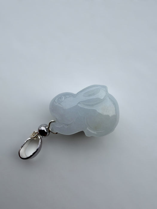 Dreamy Jade rabbit pendant carved from translucent light grey jade with a polished silver-tone bail on a white surface.