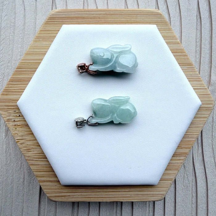 Dreamy Jade rabbit pendants in translucent green jade with rose gold and silver pavé-set stone bails on a display