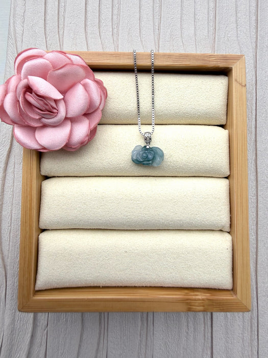 Dreamy Jade elegant rose-carved green jade pendant on a silver box chain displayed in a wooden jewellery tray