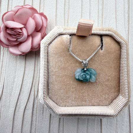Dreamy Jade rose pendant necklace featuring carved green jade on a silver box chain inside a velvet jewellery box.