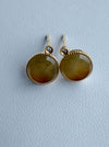 Dreamy Jade round stud earrings featuring warm-toned polished jade stones in gold-tone settings with sparkling accents.