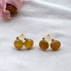 Dreamy Jade round stud earrings featuring warm-toned jade stones in gold-tone settings with sparkling accent stones.