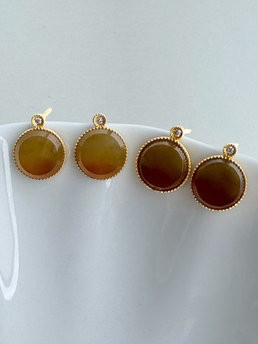 Dreamy Jade round stud earrings featuring warm-toned jade stones in gold-tone settings with sparkling accent crystals.