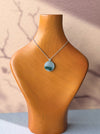 Dreamy Jade round pendant necklace featuring a green jade disc on a silver chain with a floral-inspired bail