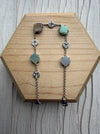 Dreamy Jade sterling silver bracelet featuring multi-coloured jade clover charms and intricate coin-inspired accents.
