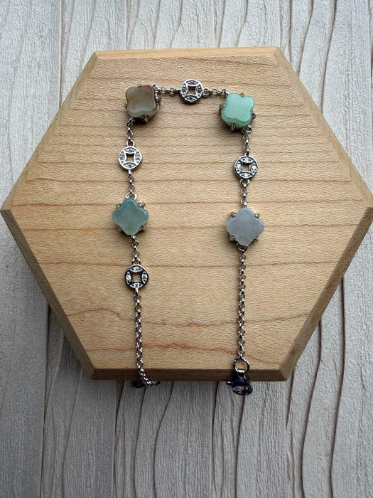 Dreamy Jade sterling silver bracelet featuring multi-coloured jade clover charms and intricate coin-inspired accents.