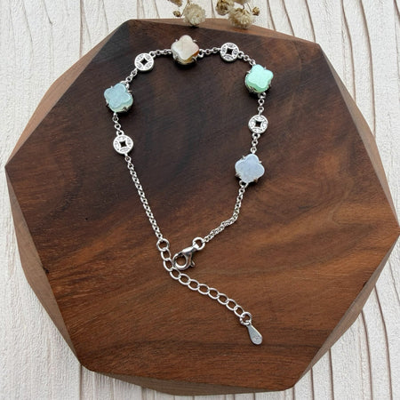 Dreamy Jade sterling silver bracelet featuring multi-coloured jade clover charms and intricate coin-inspired accents.
