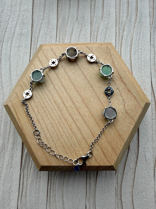 Dreamy Jade sterling silver bracelet featuring multi-coloured jade stones and intricate coin-inspired silver charms.