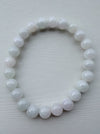 Dreamy Jade round bead bracelet featuring polished, translucent white natural jade stones on a stretchable cord.