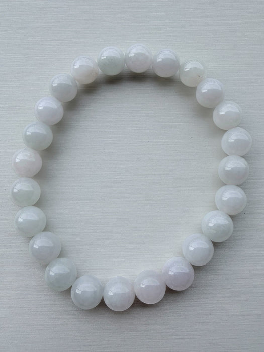 Dreamy Jade round bead bracelet featuring polished, translucent white natural jade stones on a stretchable cord.